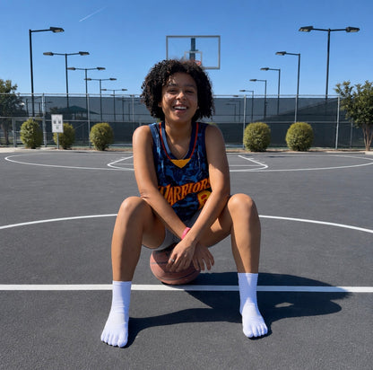 Basketball player wearing white 1st ERA Performance Toe Socks with five-toe separation on an outdoor court
